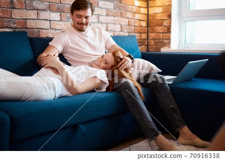 adorable pregnant woman lie on man's knees adorable pregnant woman lie on man's knees 70916338