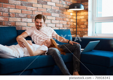 married couple expecting baby, lie on sofa married couple expecting baby, lie on sofa 70916341