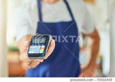 Paying terminal in businessman hand Paying terminal in businessman hand 70916409