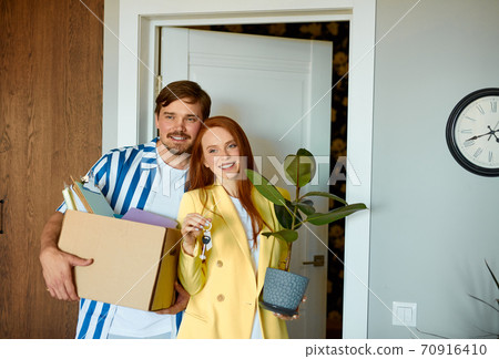 young married couple got keys from their new house young married couple got keys from their new house 70916410