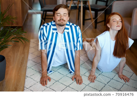 portrait of couple stretching before yoga portrait of couple stretching before yoga 70916476