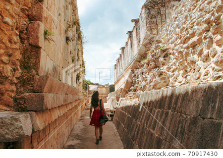 Woman at ruins of the ancient city of Uxmal in Merida, Mexico Woman at ruins of the ancient city of Uxmal in Merida, Mexico 70917430