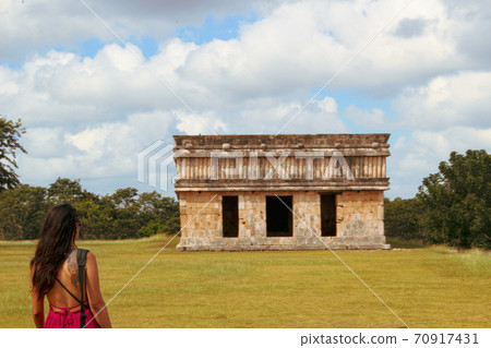 Woman at ruins of the ancient city of Uxmal in Merida, Mexico Woman at ruins of the ancient city of Uxmal in Merida, Mexico 70917431