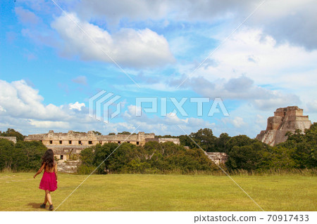 Woman at ruins of the ancient city of Uxmal in Merida, Mexico 70917433