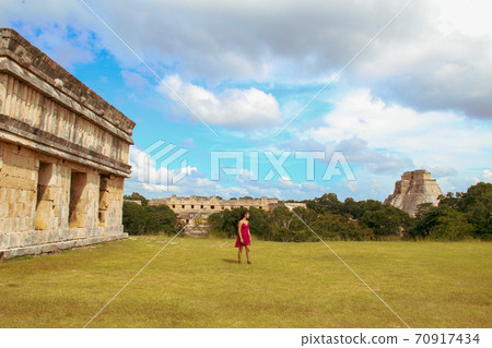 Woman at ruins of the ancient city of Uxmal in Merida, Mexico Woman at ruins of the ancient city of Uxmal in Merida, Mexico 70917434
