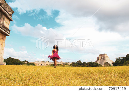 Woman at ruins of the ancient city of Uxmal in Merida, Mexico Woman at ruins of the ancient city of Uxmal in Merida, Mexico 70917439