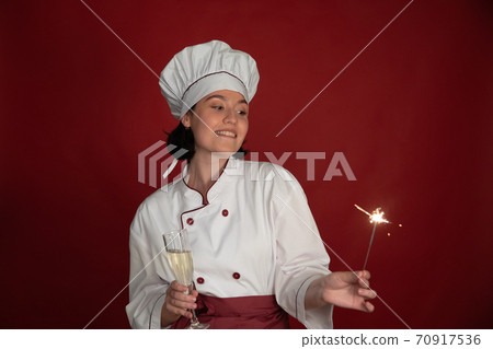 sexy female chef celebrates New Year with glass champagne and Burning sparklers sexy female chef celebrates New Year with glass champagne and Burning sparklers 70917536