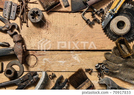 Old vintage household hand tools on a wooden background as frame and place for text 70917833