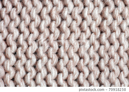 Texture beige acrylic knitted sweater. Garter stitch knitting pattern close up 70918238
