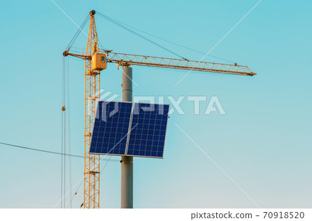 Small solar panel on top electric pole by blue sky 70918520