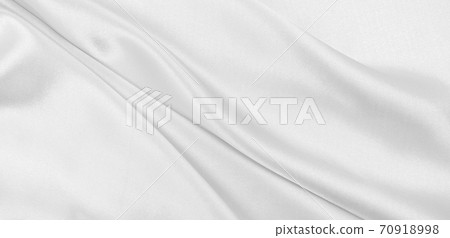 Smooth elegant white silk or satin luxury cloth texture as wedding background. Luxurious background design Smooth elegant white silk or satin luxury cloth texture as wedding background. Luxurious background design 70918998