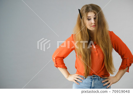 Woman having tangled hair 70919048