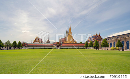 Golden pagoda at Temple of the Emerald Buddha in Bangkok, Thailand. Wat Phra Kaew and Grand palace in old town, urban city. Buddhist temple, Thai architecture. A tourist attraction Golden pagoda at Temple of the Emerald Buddha in Bangkok, Thailand. Wat Phra Kaew and Grand palace in old town, urban city. Buddhist temple, Thai architecture. A tourist attraction 70919335