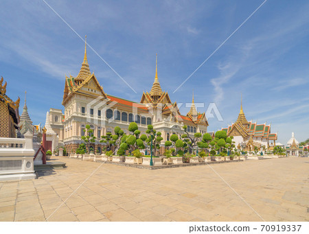 Golden pagoda at Temple of the Emerald Buddha in Bangkok, Thailand. Wat Phra Kaew and Grand palace in old town, urban city. Buddhist temple, Thai architecture. A tourist attraction Golden pagoda at Temple of the Emerald Buddha in Bangkok, Thailand. Wat Phra Kaew and Grand palace in old town, urban city. Buddhist temple, Thai architecture. A tourist attraction 70919337