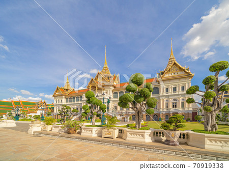 Golden pagoda at Temple of the Emerald Buddha in Bangkok, Thailand. Wat Phra Kaew and Grand palace in old town, urban city. Buddhist temple, Thai architecture. A tourist attraction Golden pagoda at Temple of the Emerald Buddha in Bangkok, Thailand. Wat Phra Kaew and Grand palace in old town, urban city. Buddhist temple, Thai architecture. A tourist attraction 70919338