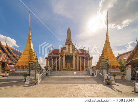 Golden pagoda at Temple of the Emerald Buddha in Bangkok, Thailand. Wat Phra Kaew and Grand palace in old town, urban city. Buddhist temple, Thai architecture. A tourist attraction 70919344