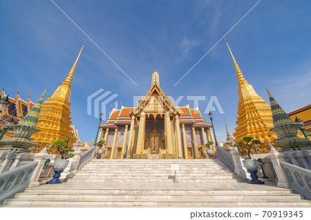Golden pagoda at Temple of the Emerald Buddha in Bangkok, Thailand. Wat Phra Kaew and Grand palace in old town, urban city. Buddhist temple, Thai architecture. A tourist attraction 70919345