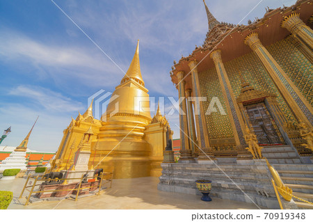 Golden pagoda at Temple of the Emerald Buddha in Bangkok, Thailand. Wat Phra Kaew and Grand palace in old town, urban city. Buddhist temple, Thai architecture. A tourist attraction 70919348