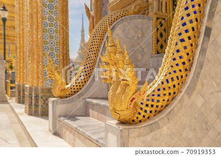 Golden pagoda at Temple of the Emerald Buddha in Bangkok, Thailand. Wat Phra Kaew and Grand palace in old town, urban city. Buddhist temple, Thai architecture. A tourist attraction Golden pagoda at Temple of the Emerald Buddha in Bangkok, Thailand. Wat Phra Kaew and Grand palace in old town, urban city. Buddhist temple, Thai architecture. A tourist attraction 70919353