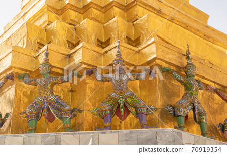 Golden pagoda at Temple of the Emerald Buddha in Bangkok, Thailand. Wat Phra Kaew and Grand palace in old town, urban city. Buddhist temple, Thai architecture. A tourist attraction Golden pagoda at Temple of the Emerald Buddha in Bangkok, Thailand. Wat Phra Kaew and Grand palace in old town, urban city. Buddhist temple, Thai architecture. A tourist attraction 70919354