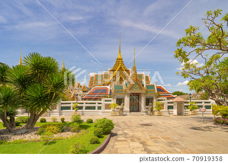 Golden pagoda at Temple of the Emerald Buddha in Bangkok, Thailand. Wat Phra Kaew and Grand palace in old town, urban city. Buddhist temple, Thai architecture. A tourist attraction Golden pagoda at Temple of the Emerald Buddha in Bangkok, Thailand. Wat Phra Kaew and Grand palace in old town, urban city. Buddhist temple, Thai architecture. A tourist attraction 70919358