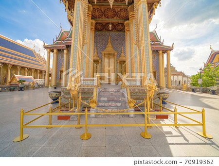 Golden pagoda at Temple of the Emerald Buddha in Bangkok, Thailand. Wat Phra Kaew and Grand palace in old town, urban city. Buddhist temple, Thai architecture. A tourist attraction 70919362