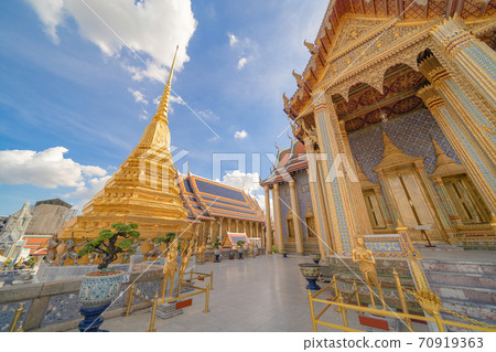 Golden pagoda at Temple of the Emerald Buddha in Bangkok, Thailand. Wat Phra Kaew and Grand palace in old town, urban city. Buddhist temple, Thai architecture. A tourist attraction Golden pagoda at Temple of the Emerald Buddha in Bangkok, Thailand. Wat Phra Kaew and Grand palace in old town, urban city. Buddhist temple, Thai architecture. A tourist attraction 70919363