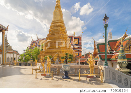 Golden pagoda at Temple of the Emerald Buddha in Bangkok, Thailand. Wat Phra Kaew and Grand palace in old town, urban city. Buddhist temple, Thai architecture. A tourist attraction 70919364