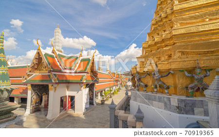 Golden pagoda at Temple of the Emerald Buddha in Bangkok, Thailand. Wat Phra Kaew and Grand palace in old town, urban city. Buddhist temple, Thai architecture. A tourist attraction Golden pagoda at Temple of the Emerald Buddha in Bangkok, Thailand. Wat Phra Kaew and Grand palace in old town, urban city. Buddhist temple, Thai architecture. A tourist attraction 70919365