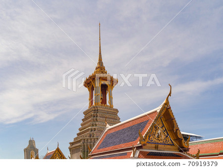 Golden pagoda at Temple of the Emerald Buddha in Bangkok, Thailand. Wat Phra Kaew and Grand palace in old town, urban city. Buddhist temple, Thai architecture. A tourist attraction Golden pagoda at Temple of the Emerald Buddha in Bangkok, Thailand. Wat Phra Kaew and Grand palace in old town, urban city. Buddhist temple, Thai architecture. A tourist attraction 70919379
