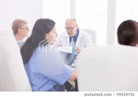 Mature doctor reading health raport 70919792