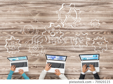 Top view of businesspeople sitting at table and using gadgets 70920115