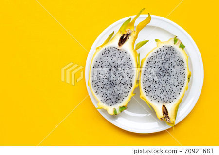Yellow pitahaya or dragon fruit on yellow background. 70921681