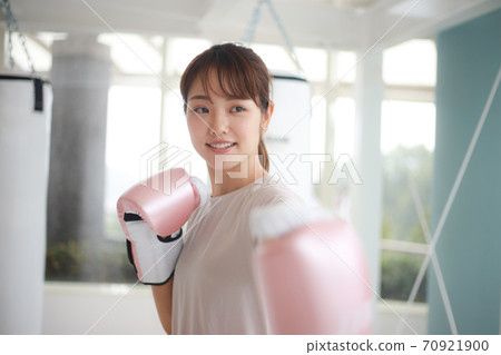 Woman hitting a mitt Woman hitting a mitt 70921900