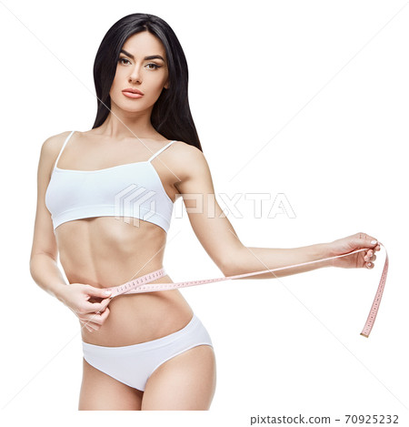 Slim tanned woman's body isolated on white background - waist measurement 70925232