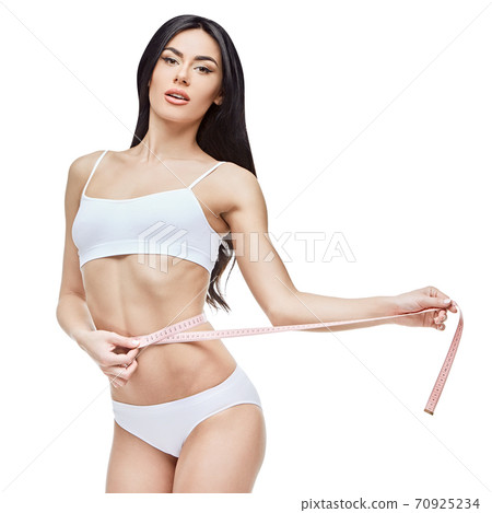 Slim tanned woman's body isolated on white background - waist measurement 70925234