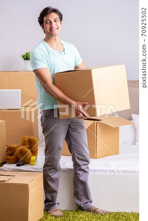 Young man moving to new apartment Young man moving to new apartment 70925502