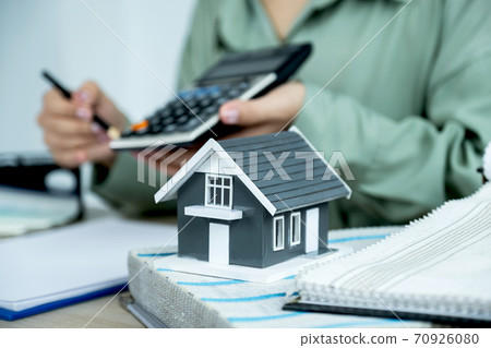 Home model standing in front of  the property and interior agents are presenting houses and curtains for interior decoration 70926080