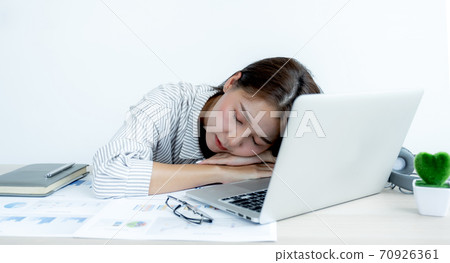 Sad Asian businesswoman employee unhappy working with bored on the laptop and chart in the office tired, Office Syndrome Concept 70926361