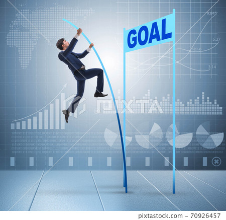 Businessman pole vaulting towards his goal in business concept 70926457