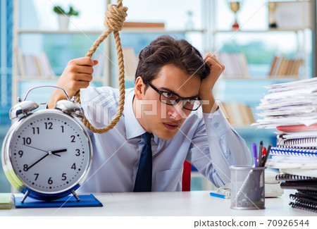 Unhappy businessman thinking of hanging himself in the office Unhappy businessman thinking of hanging himself in the office 70926544