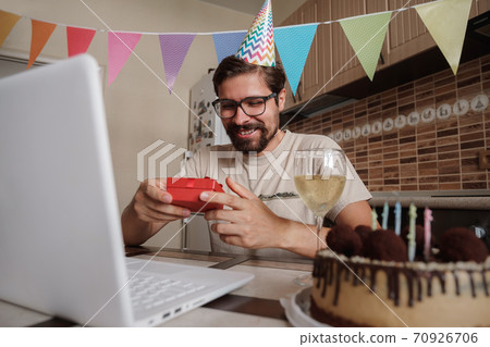 Man celebrating birthday online in quarantine time. 70926706