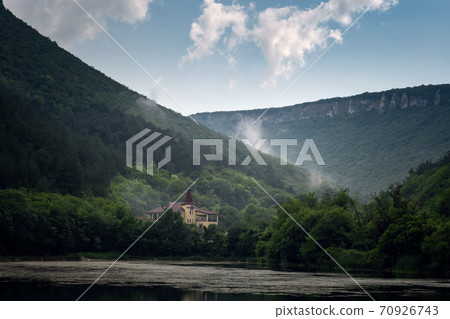 Dark and Foggy lake with hills. after the rain 70926743