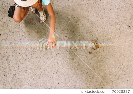 Touching rainbow. Good times are coming. A girl holding her hand under rainbow. Touching rainbow. Good times are coming. A girl holding her hand under rainbow. 70928227