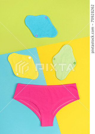 Eco sanitary reusable pads and underpants on colored background. Health care and zero-waste, no plastic concept. Top view Flat lay Eco sanitary reusable pads and underpants on colored background. Health care and zero-waste, no plastic concept. Top view Flat lay 70928262