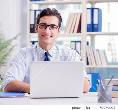 Businessman with excessive work paperwork working in office 70929001