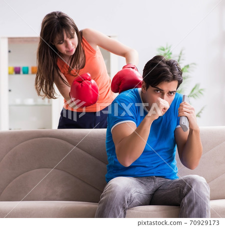 Wife unhappy that husband is watching boxing Wife unhappy that husband is watching boxing 70929173