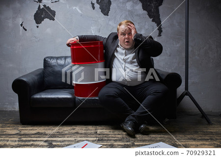 displeased male in desperate, sits in contemplation 70929321