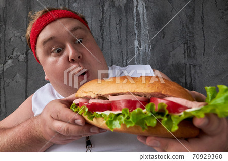 overweight man can not adhere to a healthy lifestyle and diet 70929360