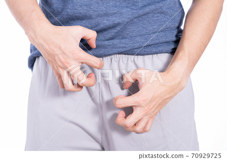 Man hands scratching his crotch isolated white background. Man hands scratching his crotch isolated white background. 70929725